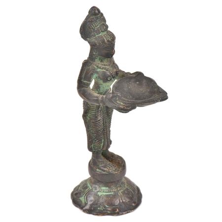 Bronze Lady Holding A Diya In Her Hand Is On A Raised Platform With Patina